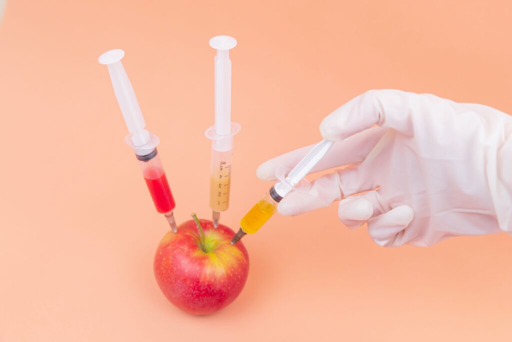 apple being injected with food additives