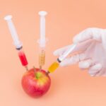 apple being injected with food additives